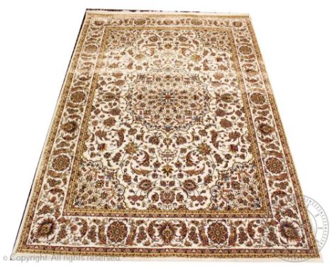 A machine woven Iranian bamboo silk carpet, worked with a central medallion and all over floral motif against an ivory colour