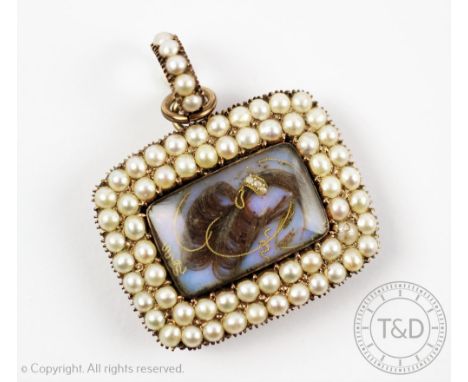 A Georgian mourning pendant, designed as a central aperture enclosing hair sprays, within a two-row surround of split seed pe