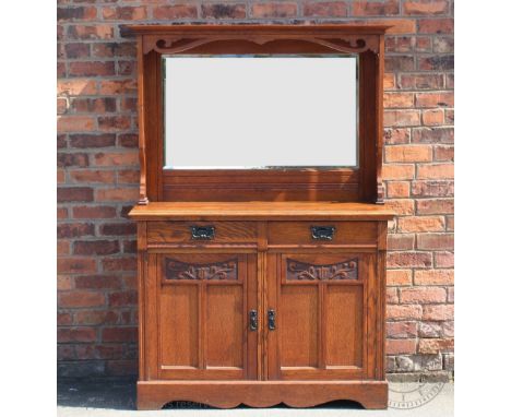 An Edwardian Arts and Crafts style oak dresser, with mirror back above two drawers and two cupboard doors, on bracket feet, 1
