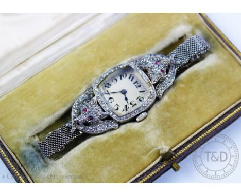 A fine French Art Deco diamond set cocktail wristwatch circa 1920, the cushion shaped dial with diamond set bezel, flanked by