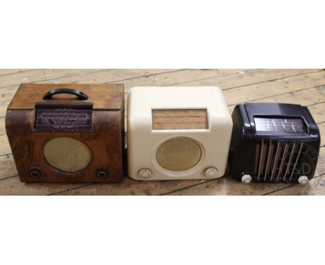 A Bush stained beech valve radio, model DCA 90A, with a bush bakelie radio, another vintage radio, a novelty radio modelled a