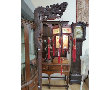An early 20th century Chinese hardwood dragon lamp stand, with a hexagonal shade, raised on a carved column, 190cm high