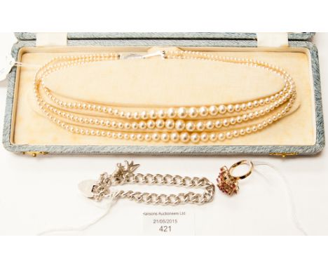 A boxed three string faux pearl necklace, with a silver charm bracelet, weighing approx 1.11 ozt and a yellow metal dress rin