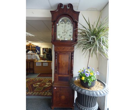 An early 19th century mahogany eight day longcase clock, the hood with swan neck pediment, the glazed face door opening to re