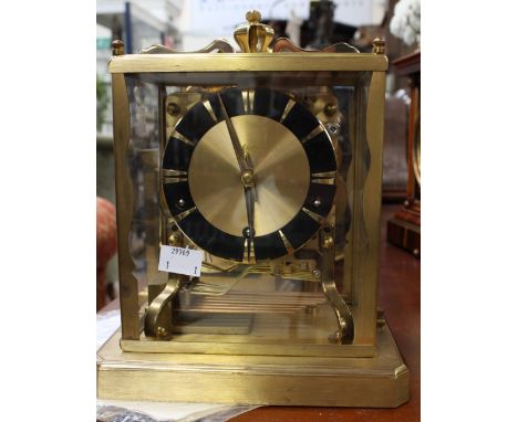 A German Schatz mantle clock, seven jewel movement and eight 'bell' chime in a lacquered brass case, with four inch dial 