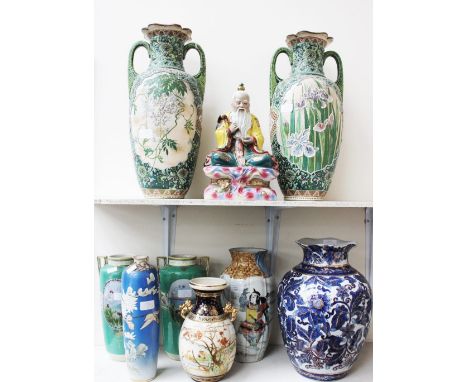 A pair of Japanese raised enamel twin handled vases, in predominately green; together with a brightly enamelled seated Immort