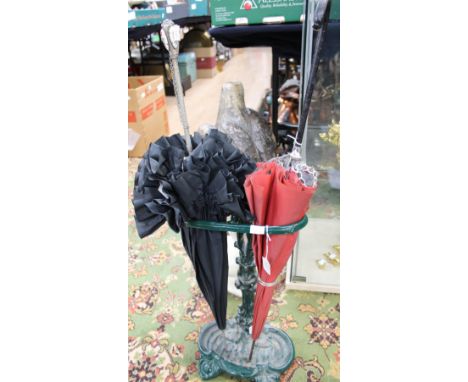 A reproduction Victorian style green painted stick stand; together with two umbrellas 