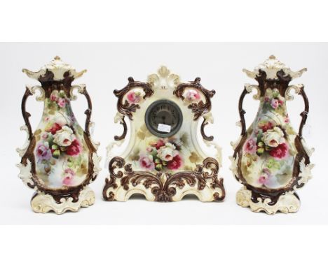 A late Victorian ceramic garniture clock set, in the Rococo style, comprising mantle clock and a pair of two handled vases, t