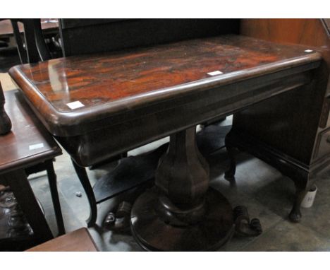 An early Victorian rosewood card table, raised on a platform pedestal base.