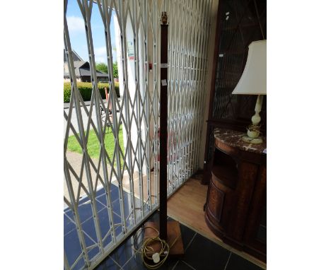 An Art Deco style walnut veneered standard lamp.