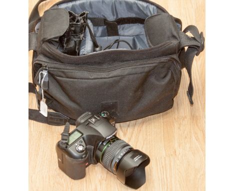 A camera carrying case containing a Pentax K10 camera, plus flash light, complete with carrying case 