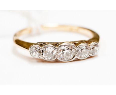 An 18ct gold five stone diamond ring, set five graduated old cut diamonds in rub over setting 