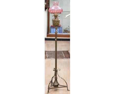 A late Victorian brass standard oil lamp, with a pink glass shade