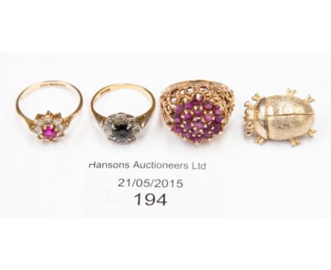 A 9ct gold and ruby ring; a sapphire and diamond chip ring; a 9ct dress ring; and a novelty brooch (4)