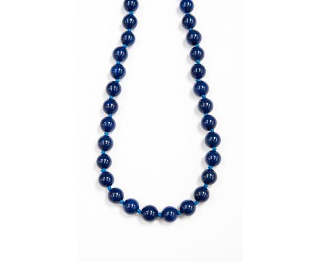 A Lapis Lazuli single strand bead necklace, with approximately 36 round 10mm beads, each individually knotted, fitted on a wh