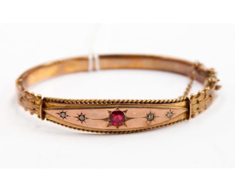 A Victorian 9ct gold bangle, set with diamonds and a ruby