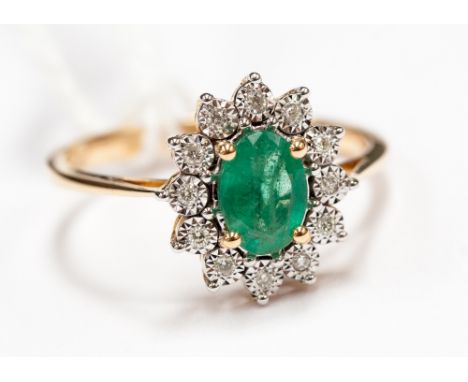 An 18ct gold emerald and diamond ring