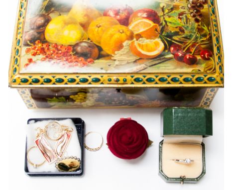 An early 20th Century biscuit tin printed fruit and flowers with lock (and key) containing a collection of jewellery includin