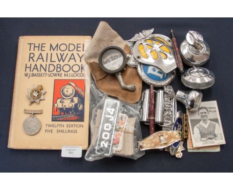 A collection of miscellaneous items, including car parts, MG gear stick knot, AA badge, Triumph badge, locks, Conway Stewart 