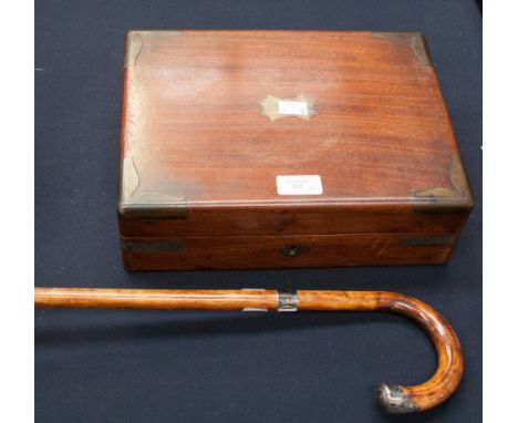 A mahogany writing slope, having brass corners and leather interior with three original jars, with a silver collared and end 