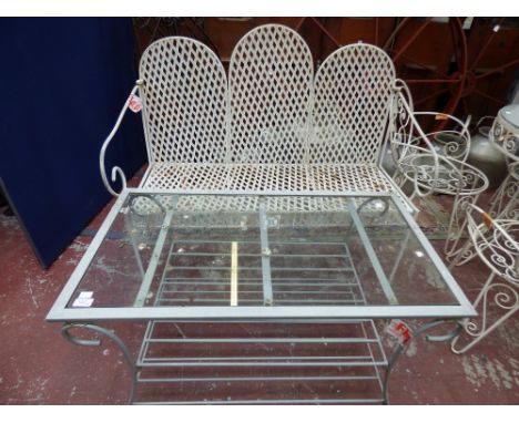 A white painted wrought iron garden bench together with a glass topped coffee table, (2)