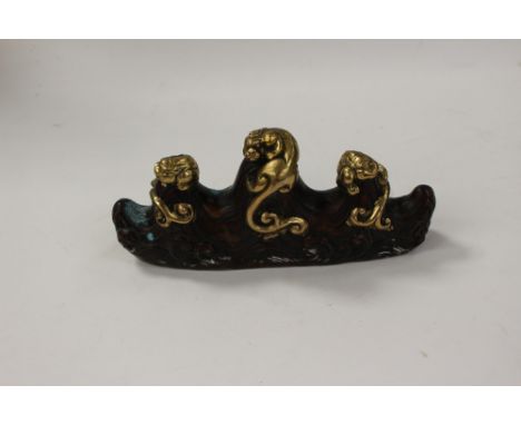 A bronze and brass/gilt metal model of beasts on waves