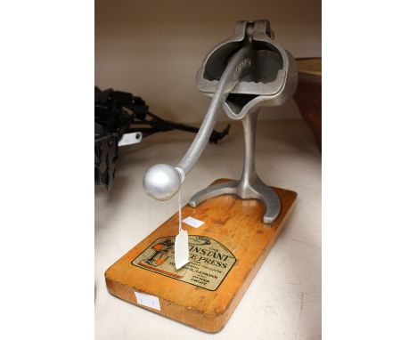 A late 1940s/early 1950s instant juice press - with a Space Age look, Instant No. 1 mounted on wooden base with transfer prin