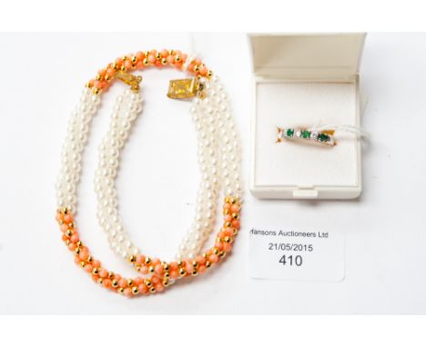 A yellow metal ring, set with three clear stones and three emerald type stones, with an Isle of Wight pear; and coral style t