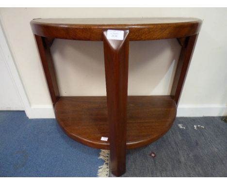 An Art Deco style hardwood console table, demi-lune form on three legs, united by a lower shelf