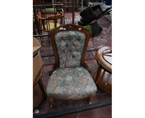 A mid Victorian mahogany ladies chair with button back and upholstered seat and raised on turned legs.