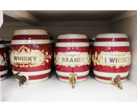 Eight Victorian ceramic spirit barrels including Whisky and Portwine, with brass taps