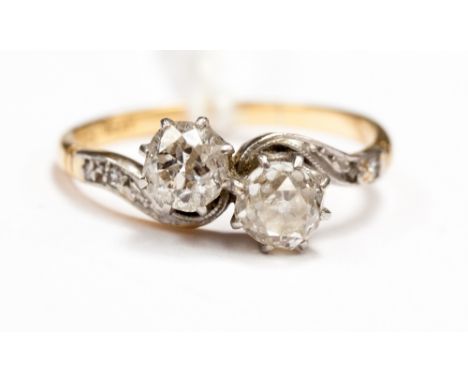 A two stone diamond ring in crossover setting, with two old cut diamonds, each approx 0.5ct 