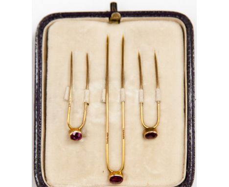 A set of Asprey London gold and ruby cravat pins in fitted box 