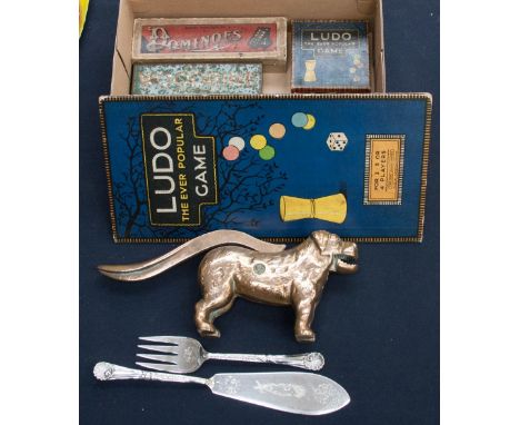 A box containing dominoes, Ludo cards, cribbage board and Walker and Hall EPNS fish servers and Novelty nut cracker in the sh