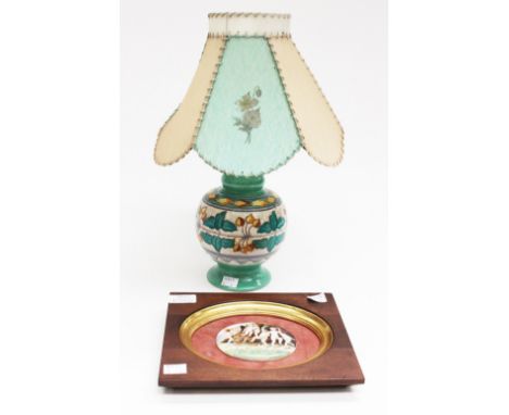 A Charlotte Rhead lamp with original shade; and a continental porcelain plaque, painted with cherubs, framed