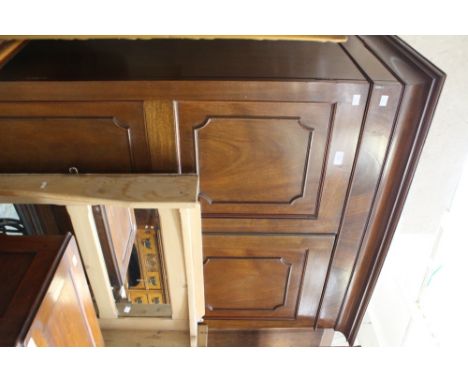 An early 20th Century mahogany double wardrobe fitted with two - panel doors, cornice AF
