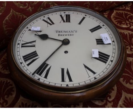 An oak cased Trumans Brewery wall clock with pendulum, Roman numerals, on enamel dial