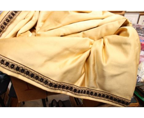 Two large gold coloured curtains, each with a black and gold fringe edge (one box) 