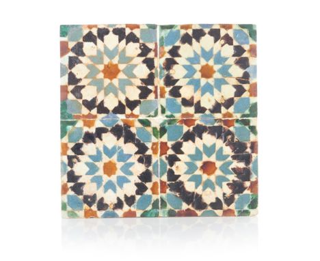 A panel of four Hispano-Moresque tilesGlazed ceramic"Aresta" technique polychrome decorationApplied onto a wooden panel16th c