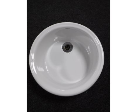 A circular Sanindusa ceramic wash basin