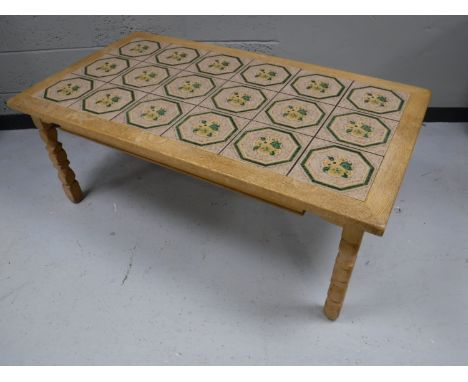 A blond oak tile top coffee table together with a contemporary glass topped coffee table