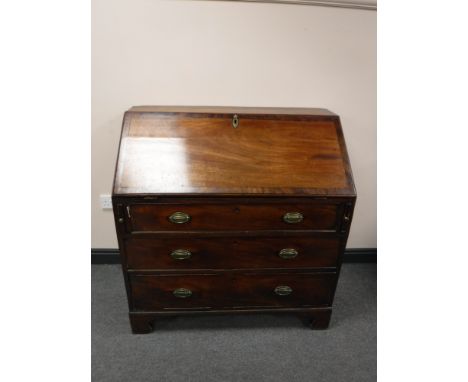 A George III mahogany bureau on bracket feet 