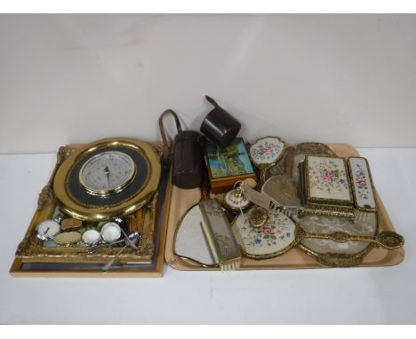 A tray containing dressing table sets, musical trinket box, barometer, pill boxes, Smiths pocket watch, a Minolta lens in lea