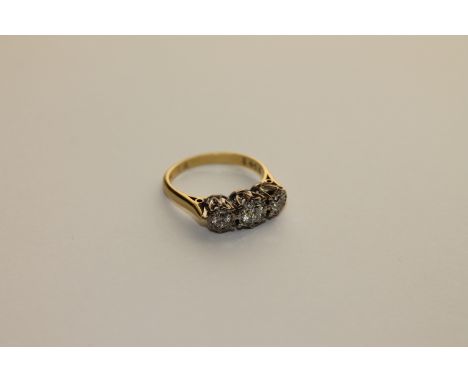 A three stone diamond ring set in 18ct gold