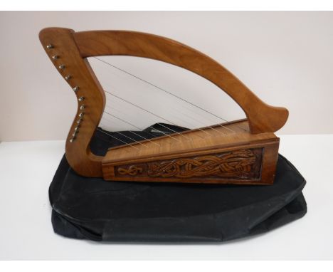 A twelve stringed Celtic harp in carry bag 