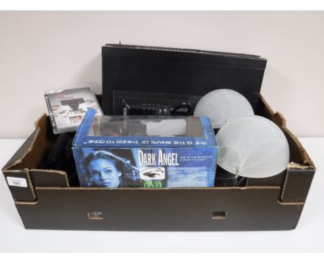 A box containing a Morantz compact disk player with remote, Playstation 3 controllers, digital camera etc