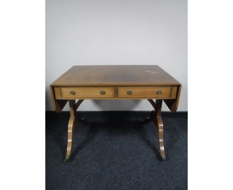 An inlaid mahogany Victorian style sofa table fitted two drawers