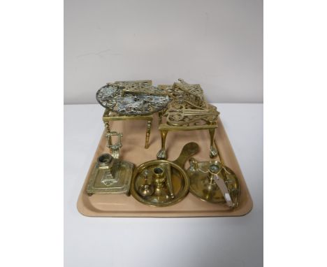 A tray containing brass candle holders, brass trivets, toasting fork etc