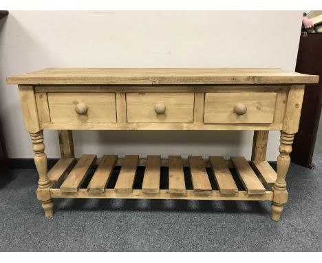 A reclaimed pine three drawer side table, width 140 cm 