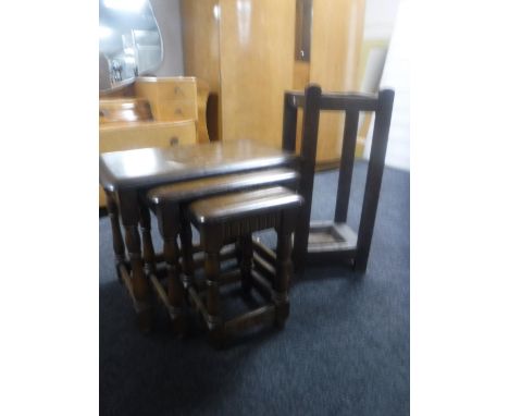 A nest of three oak tables together with an Edwardian oak stick stand 